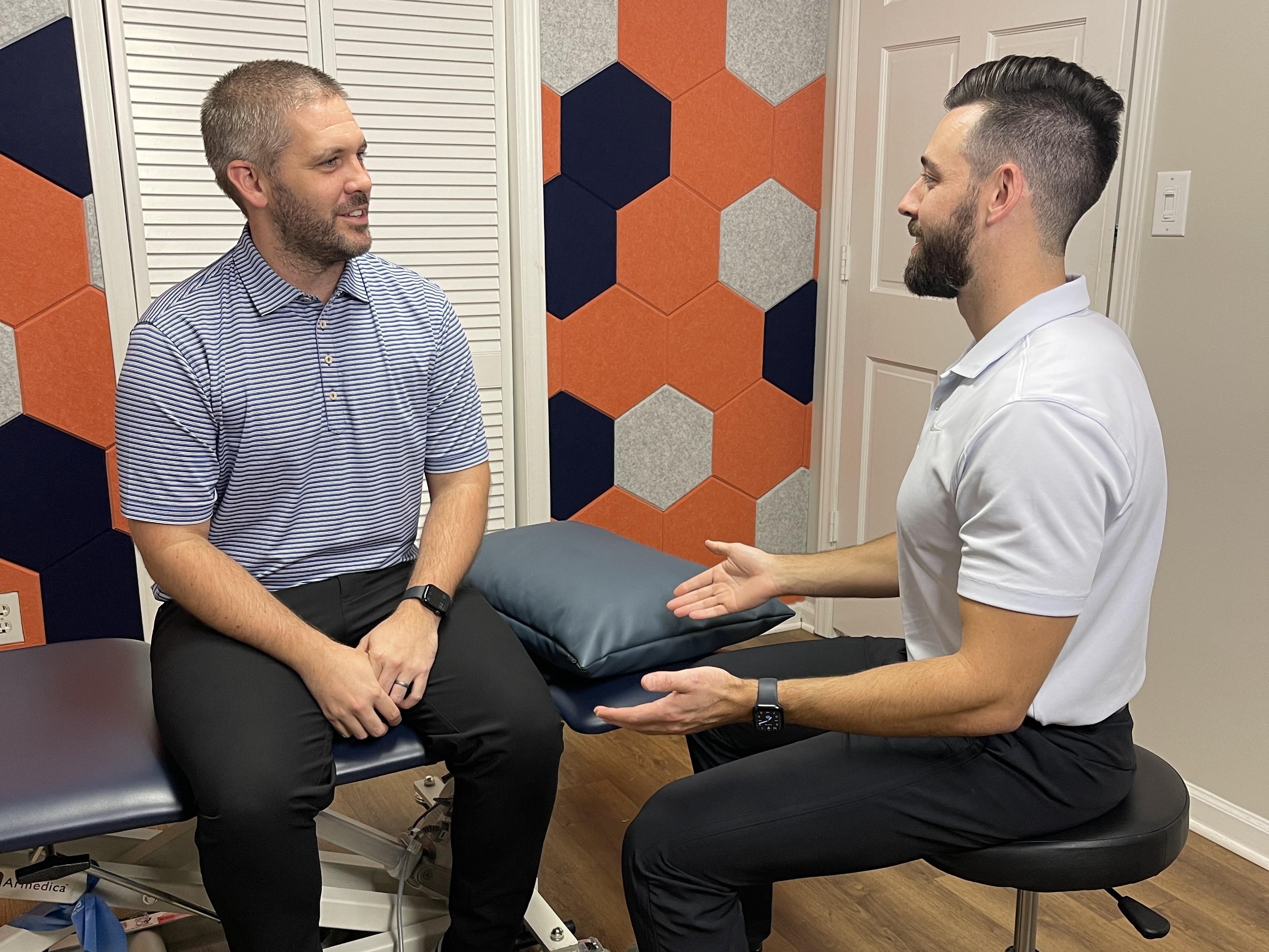 man talking with his physical therapist