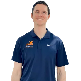 Smiling man in Nike polo shirt with Velocity logo, isolated on a clear background, exuding a professional and friendly demeanor.